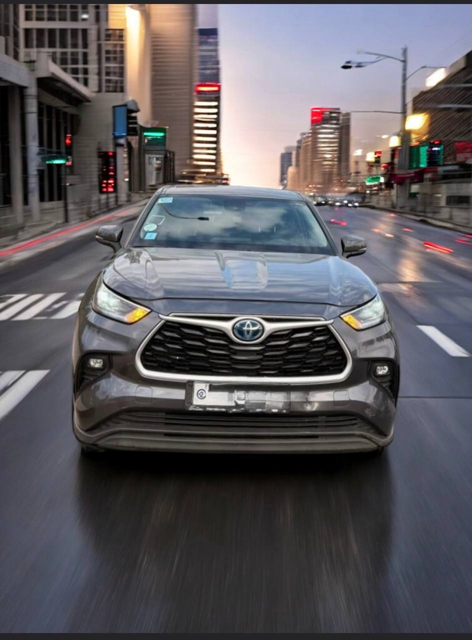 2021 Toyota Highlander Hybrid parked in a scenic location, showcasing its sleek design and advanced technology.