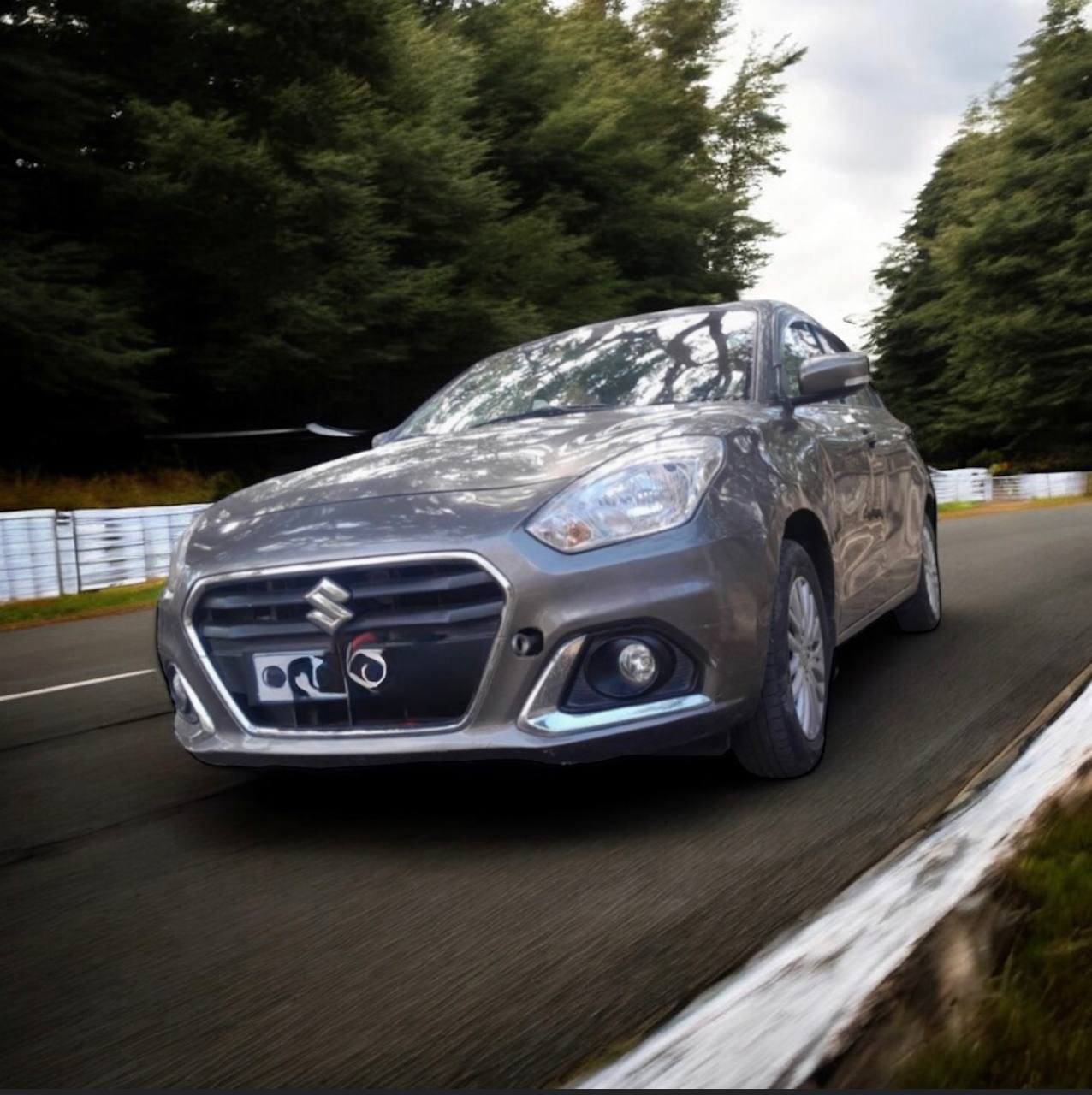 2022 Suzuki Dzire subcompact sedan parked in a scenic urban setting, showcasing its factory saddle brown exterior.