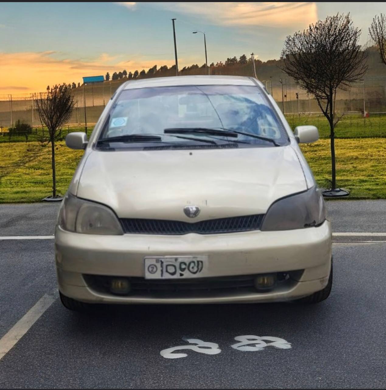 A well-maintained 2000 Toyota Platz XP10 sedan parked outside, showcasing its sleek design and reliability features, ideal for city driving.