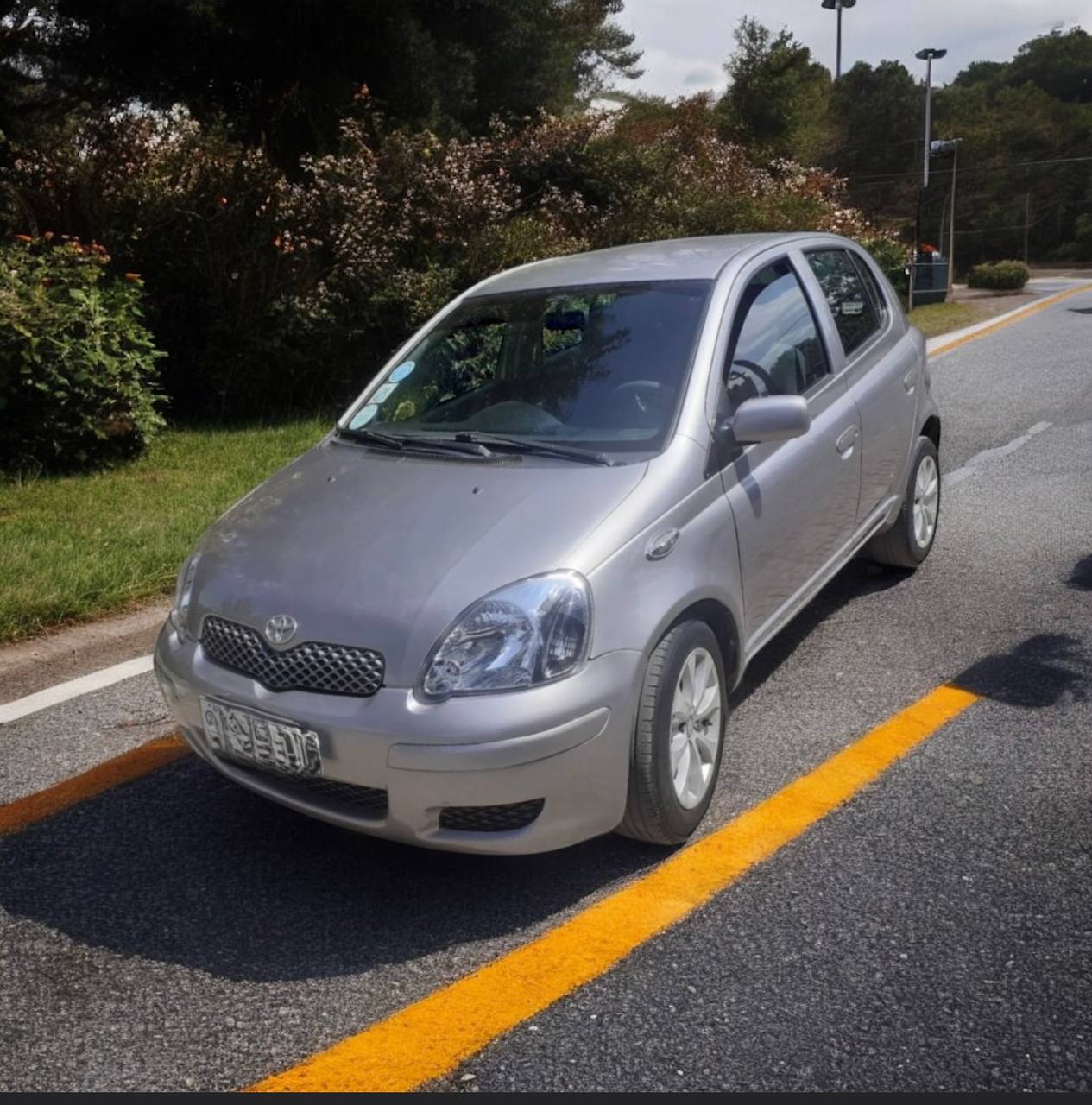 "2003 Toyota Yaris (XP10) in vibrant blue for sale, showcasing its original factory condition and 90% tire life remaining."