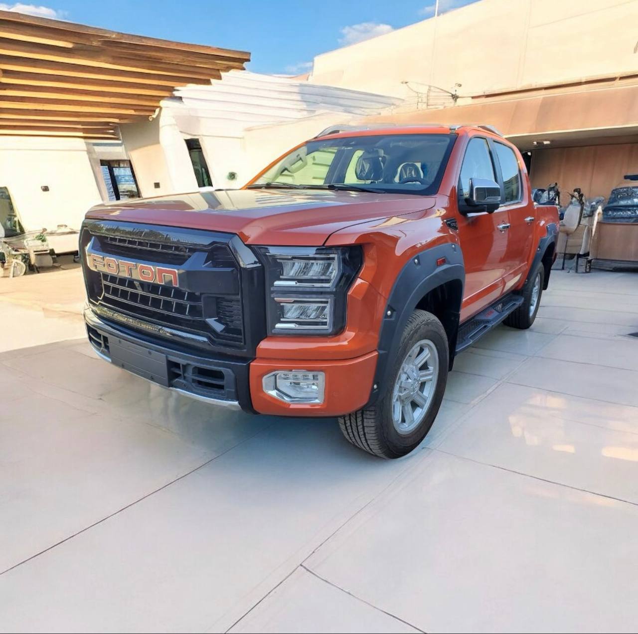 Exterior View: Front view of a brand new 2025 Foton Tunland G9 double cab pickup in Addis Ababa. Interior/Dashboard: Luxury interior of Foton Tunland G9 featuring a 10.25-inch touchscreen and leather seats. Off-Road/Side Profile: Side profile of 2025 Foton Tunland G9 4x4 showing high ground clearance and rugged design. Engine Bay: 2.0L Aucan Turbo-Diesel engine of the 2025 Foton Tunland G9.