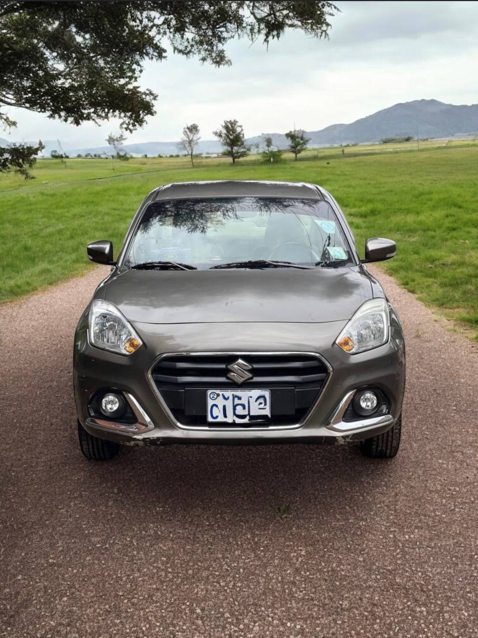 2023 Suzuki Dzire (WB) Subcompact Sedan in Saddle Brown, showcasing modern design and interior features.