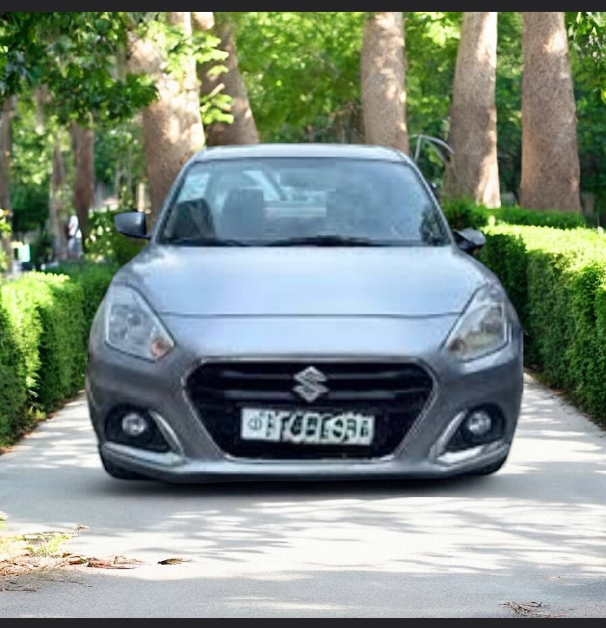 Image of a 2021 Suzuki Dzire in saddle brown with an 8-inch touchscreen interior.