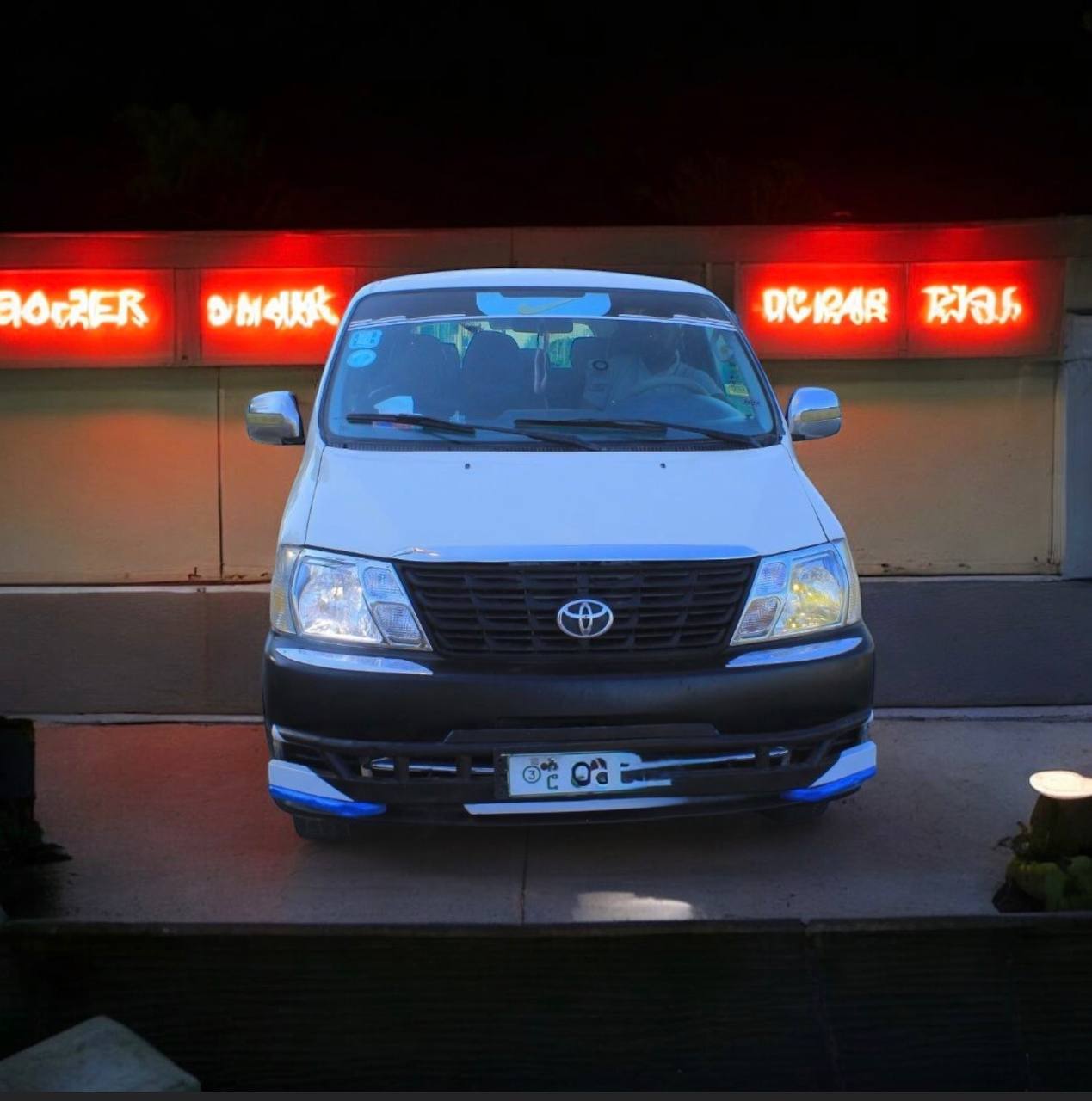 Front exterior view of a silver 2010 Toyota Granvia HiAce (XH20) parked in Addis Ababa, Ethiopia, showcasing its well-maintained factory condition and robust 2.5L engine design.