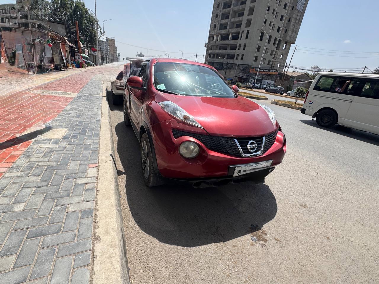Exterior front-view of a 2012 Nissan Juke (F15) in original factory white paint, parked in Addis Ababa, Ethiopia.