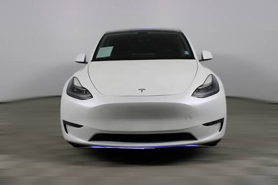Front profile of a white 2022 Tesla Model Y Ethiopia edition parked at a luxury showroom in Addis Ababa