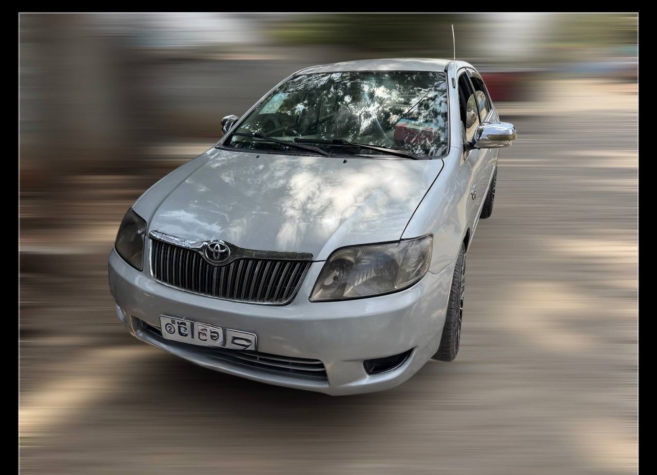 Khaki 2006 Toyota Corolla E120 sedan (LHD) with Ethiopian plate AA 2 C 36, parked in a clean urban setting