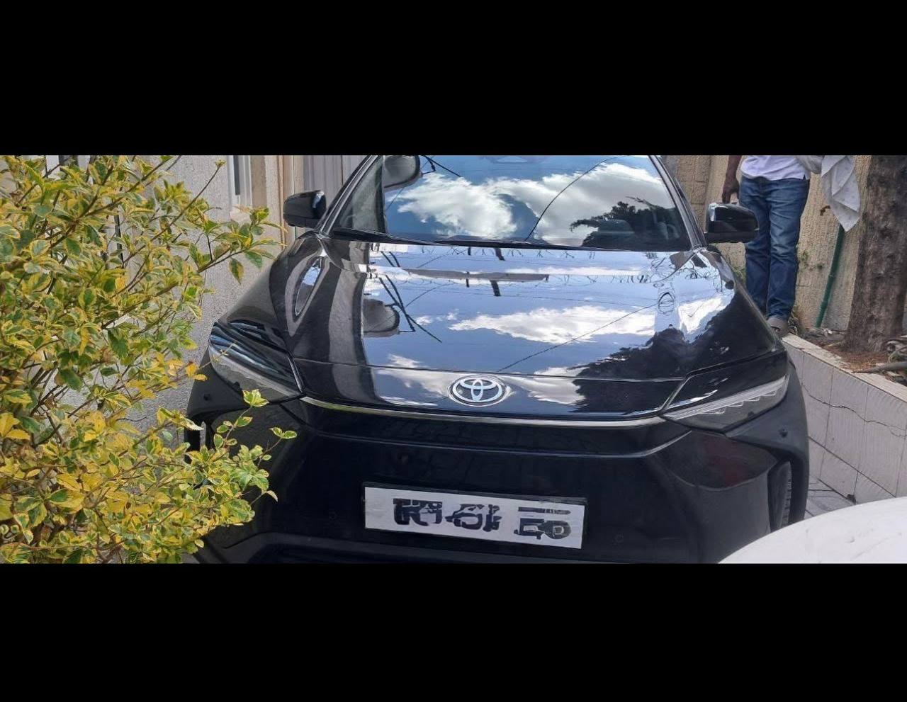 Front view of a 2023 Toyota bZ4X electric SUV in Ethiopia showing its sleek silver exterior and LED headlights.