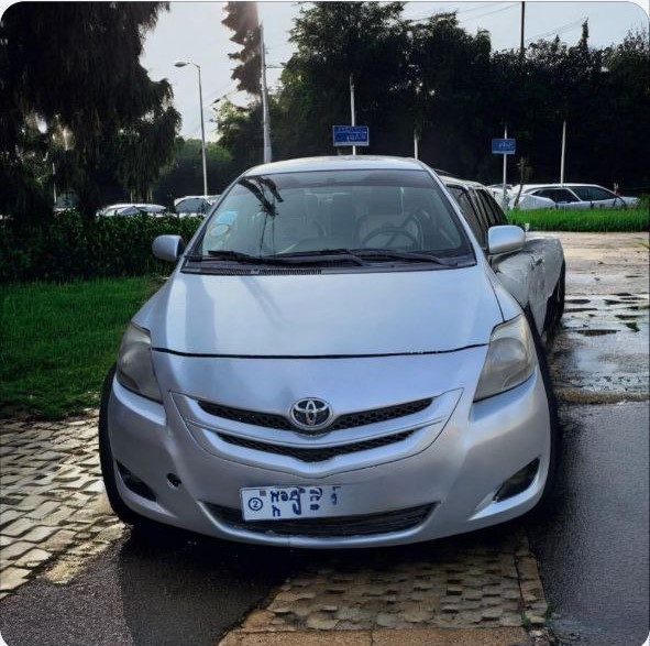 A silver 2008 Toyota Belta XP90 sedan parked on a paved surface. The car is in excellent condition with its original factory paint, clean headlights, and well-maintained tires.