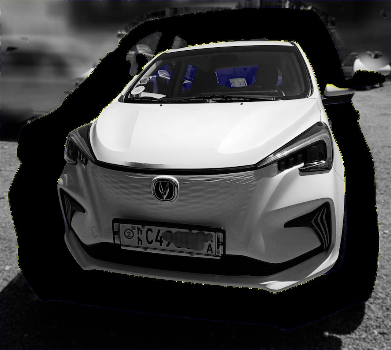 2022 Changan Benben E-Star electric car parked in an urban setting, showing the smiling front grille and LED headlights.