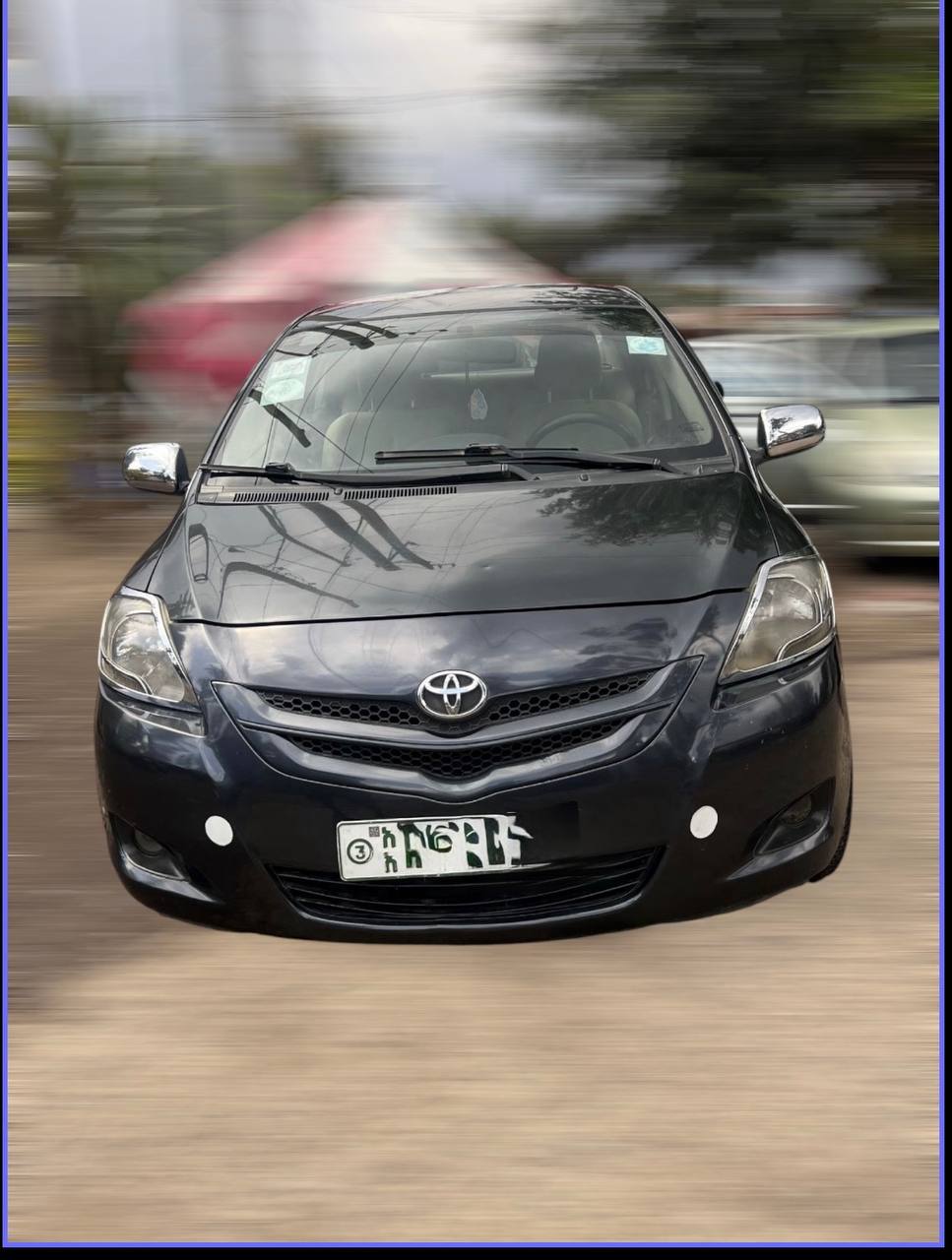 Side profile of a factory-standard 2008 Toyota Belta XP90 in Attitude Black Metallic, parked in Addis Ababa, Ethiopia.