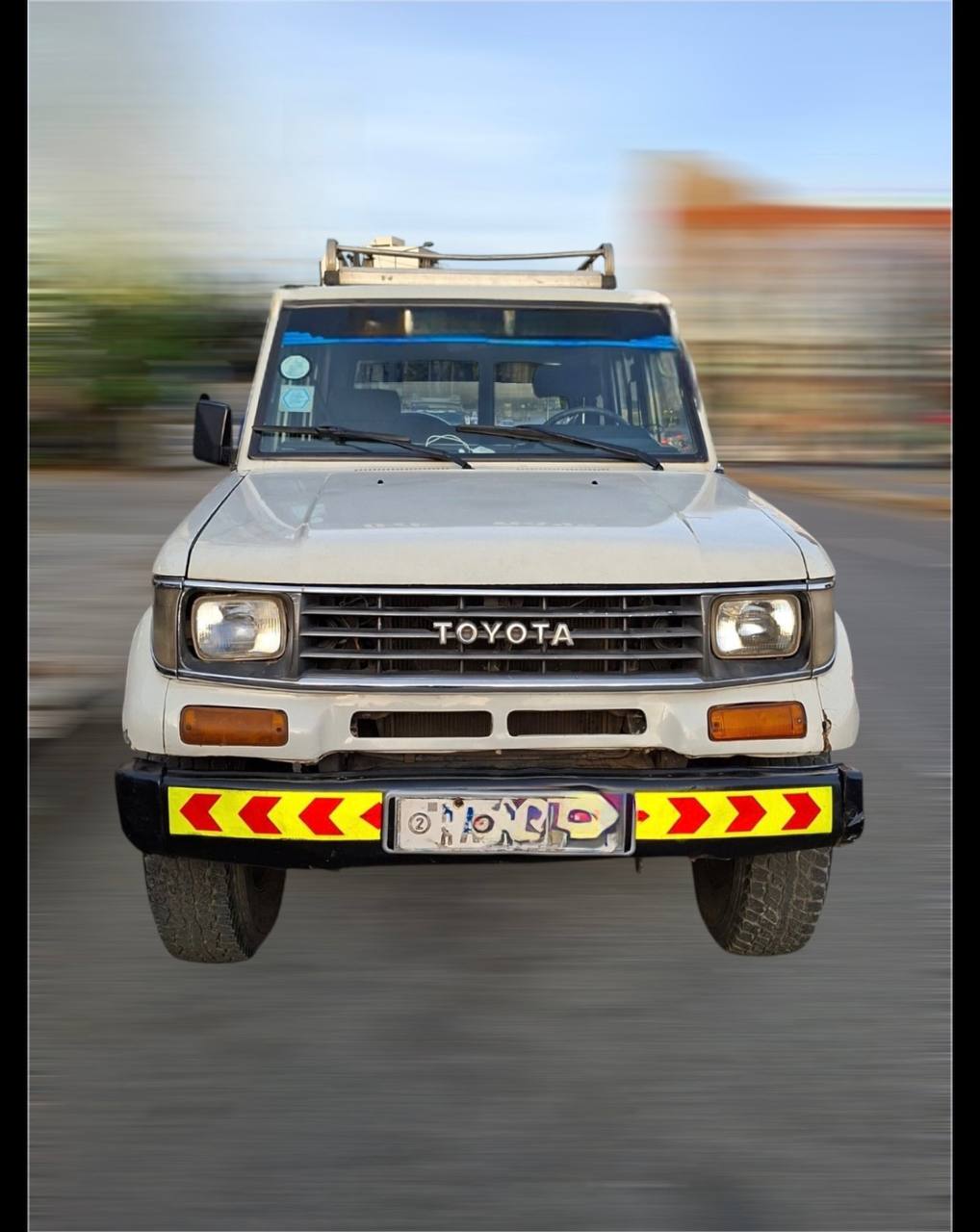 A pristine white Toyota Land Cruiser 70 Series parked in Addis Ababa Ethiopia featuring a snorkel and heavy-duty bumper.