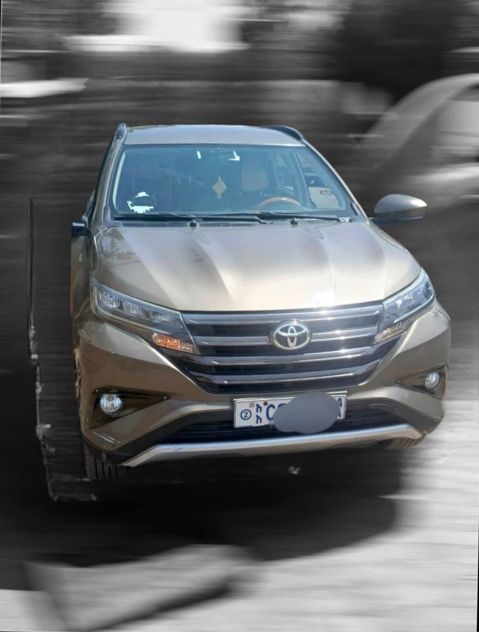 A clean 2021 Toyota Rush Price listing featuring a brown 7-seater SUV in Addis Ababa.