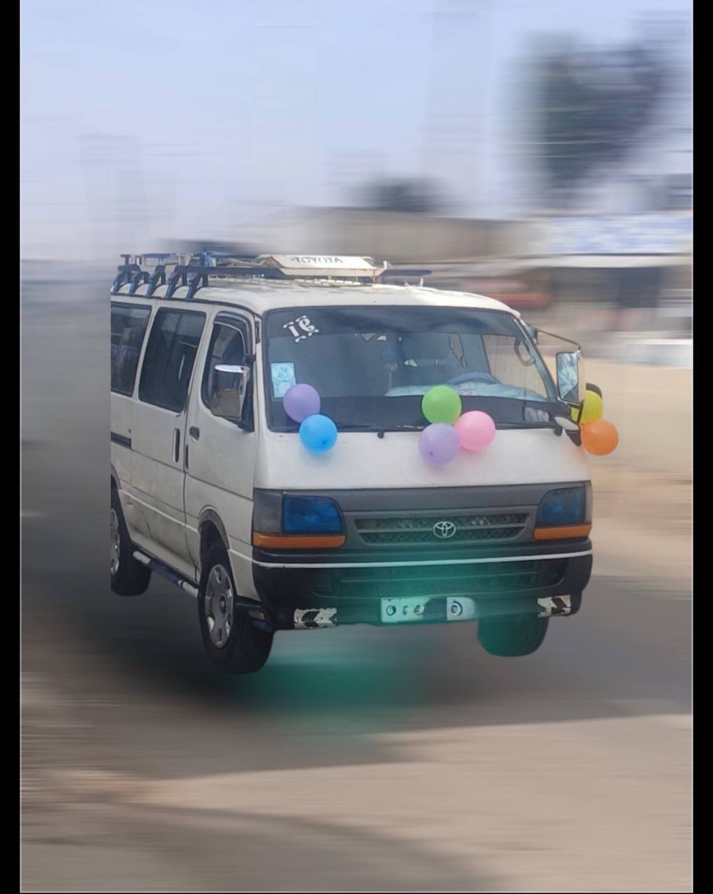 Side view of a white Toyota HiAce H100 Commuter in Addis Ababa.