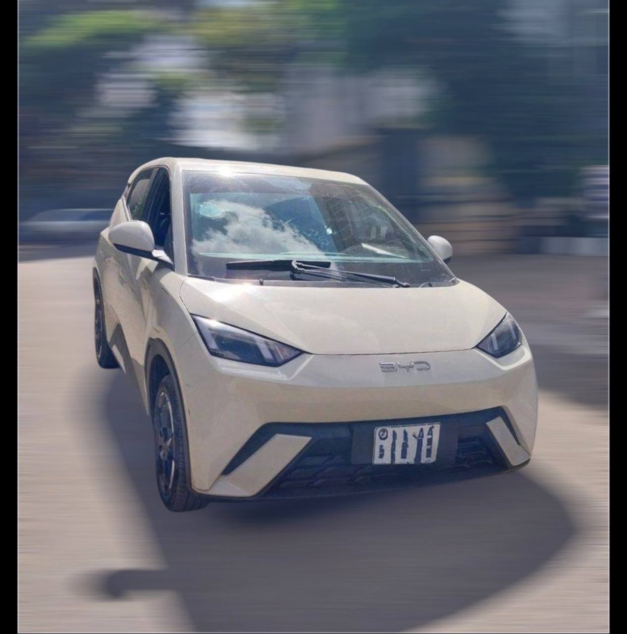 Side view of a white 2024 BYD Seagull electric city car parked in Addis Ababa, showcasing its aerodynamic design and LED headlights.