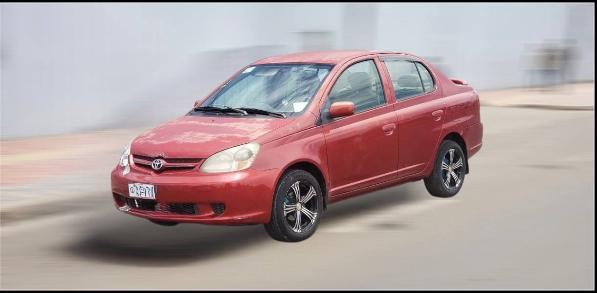 2003 Toyota Platz Ethiopia metallic red sedan side view